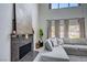 Cozy living room showcases a stylish fireplace, comfortable seating, and large windows with natural light and backyard view at 2724 Monrovia Dr, Las Vegas, NV 89117