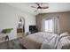 Well-lit bedroom with a ceiling fan and wood-look floors, connecting to the bathroom via an arched doorway at 2724 Monrovia Dr, Las Vegas, NV 89117