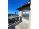 Exterior balcony features gray railing, a stucco exterior wall, and a street view from the balcony at 2818 Calle Del Oro, Las Vegas, NV 89120