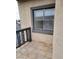 Exterior balcony features neutral tile, gray railing, and stucco exterior wall with a gray framed window at 2818 Calle Del Oro, Las Vegas, NV 89120