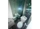 Small bathroom with a mirrored wall, enhancing the sense of space and light in the room at 2818 Calle Del Oro, Las Vegas, NV 89120