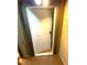 View of a condo entrance, showing a partially opened white door in a weathered entryway at 2818 Calle Del Oro, Las Vegas, NV 89120