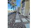 A long view of the side of the condo with pavers leading to multiple units with sliding glass doors at 2818 Calle Del Oro, Las Vegas, NV 89120