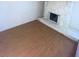 Empty living room with laminate flooring and a white stone fireplace, ready for personalization at 2818 Calle Del Oro, Las Vegas, NV 89120
