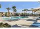 Resort-style community pool with palm trees, comfortable lounge chairs and shade structures providing a relaxing oasis at 2846 Cerulean Stars Ln # 1, Las Vegas, NV 89183