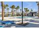 Resort-style community pool and clubhouse with palm trees, comfortable lounge chairs and picnic tables at 2846 Cerulean Stars Ln # 1, Las Vegas, NV 89183