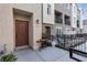 A view of townhome exteriors with patios, showcasing modern architectural details and landscaping at 2846 Cerulean Stars Ln # 1, Las Vegas, NV 89183