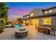 Luxurious outdoor space featuring a custom pool, fire pit, dining area and beautiful landscaping at 2908 Ferrand Ct, Henderson, NV 89044