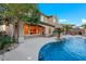 Beautiful backyard showcasing a refreshing pool with lush landscaping and a poolside bar at 2908 Ferrand Ct, Henderson, NV 89044