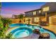 Backyard pool and spa with a rock waterfall feature, perfect for relaxation and entertainment at 2908 Ferrand Ct, Henderson, NV 89044