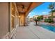 Outdoor oasis featuring a luxurious pool with spa, lush landscaping, and a cozy poolside bar area at 2908 Ferrand Ct, Henderson, NV 89044