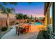 Outdoor living space includes a pool, hot tub, dining area, and fire pit for entertaining at 2908 Ferrand Ct, Henderson, NV 89044
