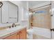Bathroom featuring neutral-toned tile, single sink vanity, and a shower-tub combo for comfort at 2908 Ferrand Ct, Henderson, NV 89044