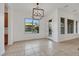 Bright dining area with tile flooring, modern lighting fixture, and views of the landscaped backyard at 2908 Ferrand Ct, Henderson, NV 89044