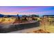 A well-landscaped home with a three-car garage and beautiful sunset sky at 2908 Ferrand Ct, Henderson, NV 89044