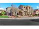 Charming two-story home featuring a portico, balcony, manicured landscaping, and a spacious driveway at 2908 Ferrand Ct, Henderson, NV 89044