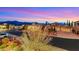 A well-manicured home featuring a mountain backdrop and a three-car garage at 2908 Ferrand Ct, Henderson, NV 89044