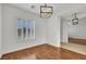 Bright living room with hardwood floors, plantation shutters, and modern light fixture at 2908 Ferrand Ct, Henderson, NV 89044