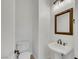 Well-lit powder room with pedestal sink, decorative mirror, and modern fixtures at 2908 Ferrand Ct, Henderson, NV 89044
