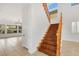 Elegant wooden staircase with high ceilings and natural light, leading to the upper level at 2908 Ferrand Ct, Henderson, NV 89044
