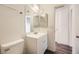 Bathroom features wood-look flooring, white vanity, and new toilet at 2916 Karen Ave, Las Vegas, NV 89121
