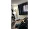 Comfortable bedroom featuring hardwood floors, a large window with coverings and black-out curtains at 2916 Karen Ave, Las Vegas, NV 89121
