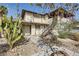 Two-story multi-Gathering unit with stairway access, accented by desert foliage and blue sky at 2916 Karen Ave, Las Vegas, NV 89121