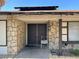 Inviting front door with stone accents and a charming chair at 2916 Karen Ave, Las Vegas, NV 89121