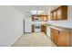 Bright kitchen features white appliances, wood cabinetry, and tile flooring at 2916 Karen Ave, Las Vegas, NV 89121