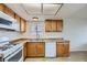 Bright kitchen features white appliances, wood cabinetry, and a double sink at 2916 Karen Ave, Las Vegas, NV 89121