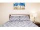 Relaxing bedroom with patterned bedding, a decorative art piece, and a bedside table, perfect for unwinding at 301 Falcon Ln, Las Vegas, NV 89107