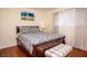 Charming bedroom with a patterned bedspread, accent bench, and sheer curtains, providing a cozy atmosphere at 301 Falcon Ln, Las Vegas, NV 89107