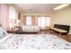 Bright and spacious bedroom with two beds, hardwood floors, and pink curtains at 301 Falcon Ln, Las Vegas, NV 89107