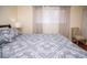 Cozy bedroom featuring neutral tones, sheer curtains, and a comfortable chair, creating a tranquil space at 301 Falcon Ln, Las Vegas, NV 89107