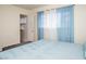 Bright bedroom with a view to walk-in closet and soft blue curtains, creating a calm and airy space at 301 Falcon Ln, Las Vegas, NV 89107