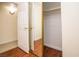 Walk-in closet featuring mirrored doors, with wood-look flooring and ample storage space at 301 Falcon Ln, Las Vegas, NV 89107