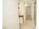 Hallway with tile flooring, a decorative table, and access to multiple rooms at 301 Falcon Ln, Las Vegas, NV 89107