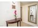Inviting hallway with a decorative table, mirror, and warm neutral tones, creating a welcoming entrance at 301 Falcon Ln, Las Vegas, NV 89107