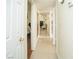 Hallway with tile flooring, a peek into other rooms, and white doors at 301 Falcon Ln, Las Vegas, NV 89107