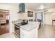 Modern kitchen featuring granite countertops, stainless steel appliances, and an open layout leading to the dining area at 301 Falcon Ln, Las Vegas, NV 89107