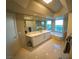Luxurious bathroom featuring a large soaking tub and dual sinks with scenic city views at 322 Karen Ave # 3407, Las Vegas, NV 89109