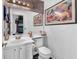 A well-lit powder room features modern fixtures, vanity lighting, and a stylish mirror with artwork at 3609 Twinbreeze St, Las Vegas, NV 89129