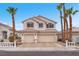 Charming two-story home featuring a two-car garage and desert landscaping with beautiful palm trees at 3609 Twinbreeze St, Las Vegas, NV 89129