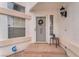 Close up of front door with welcome wreath, outdoor light fixture, and small bistro set at 3609 Twinbreeze St, Las Vegas, NV 89129