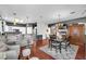 A spacious living area with hardwood floors connects the kitchen and dining room with a cozy fireplace and breakfast bar at 3609 Twinbreeze St, Las Vegas, NV 89129