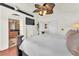 Bright main bedroom featuring a fan, TV, and an open doorway leading to the bathroom at 3609 Twinbreeze St, Las Vegas, NV 89129