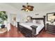 Inviting main bedroom featuring a dark wood bed frame, matching nightstand, and ceiling fan at 3609 Twinbreeze St, Las Vegas, NV 89129