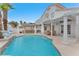 Beautiful backyard pool area with a built-in outdoor kitchen and covered patio seating at 3609 Twinbreeze St, Las Vegas, NV 89129