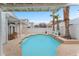 Refreshing swimming pool surrounded by palm trees and a well-maintained patio area at 3609 Twinbreeze St, Las Vegas, NV 89129