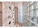 Close up of the large glass block shower with dual shower heads, niches, and black tile accents at 3609 Twinbreeze St, Las Vegas, NV 89129